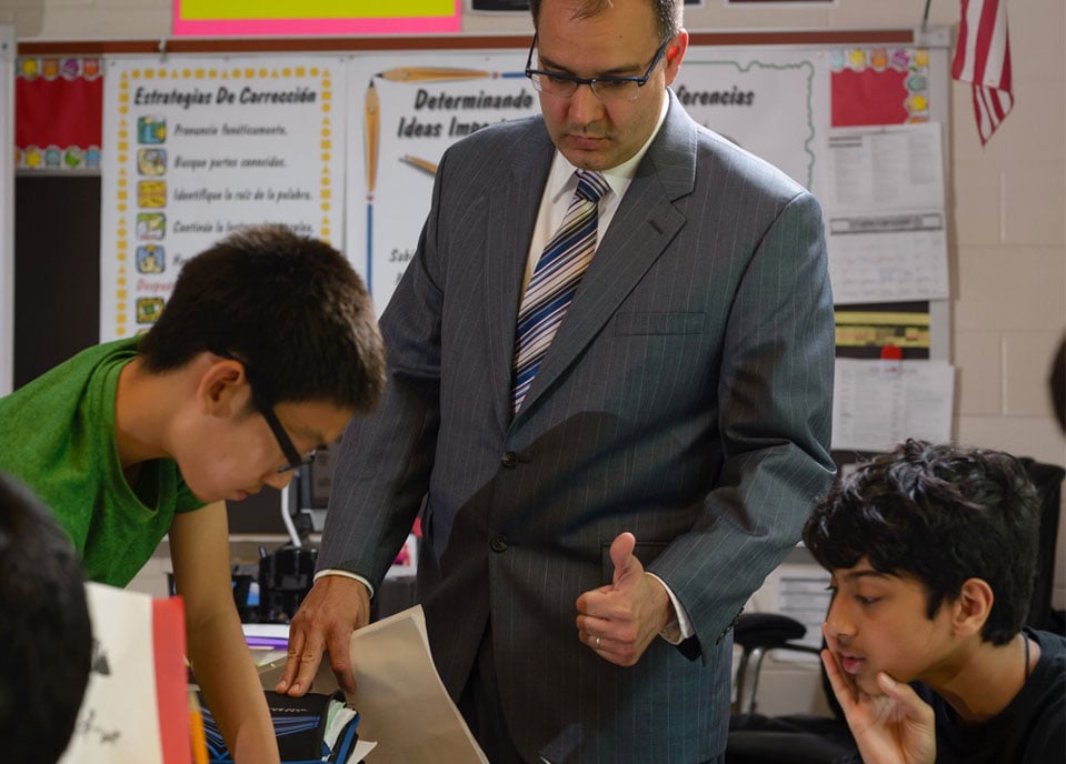 a teacher working with middleschool students