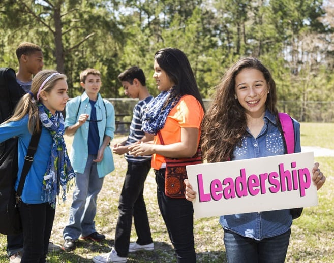 student holding leadaership sign