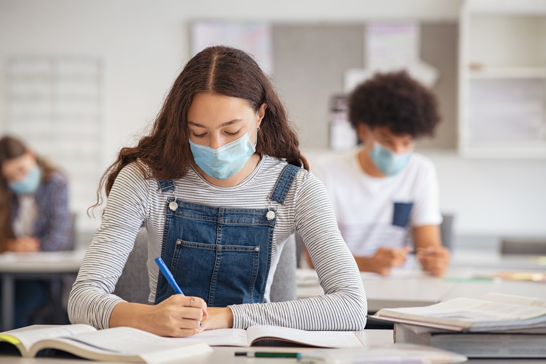 masked student at desk