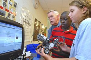 Middle school students working with electronics